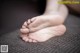 A close up of a person's bare feet on a couch.