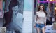 A woman standing in front of a poster on a wall.