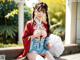 A woman in a red and blue kimono sitting on a bench.